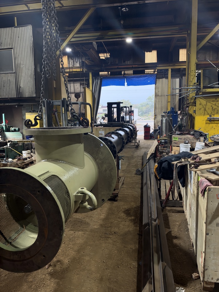 Opposite end of the large vertical pump assembly extending through the PumpRite shop
